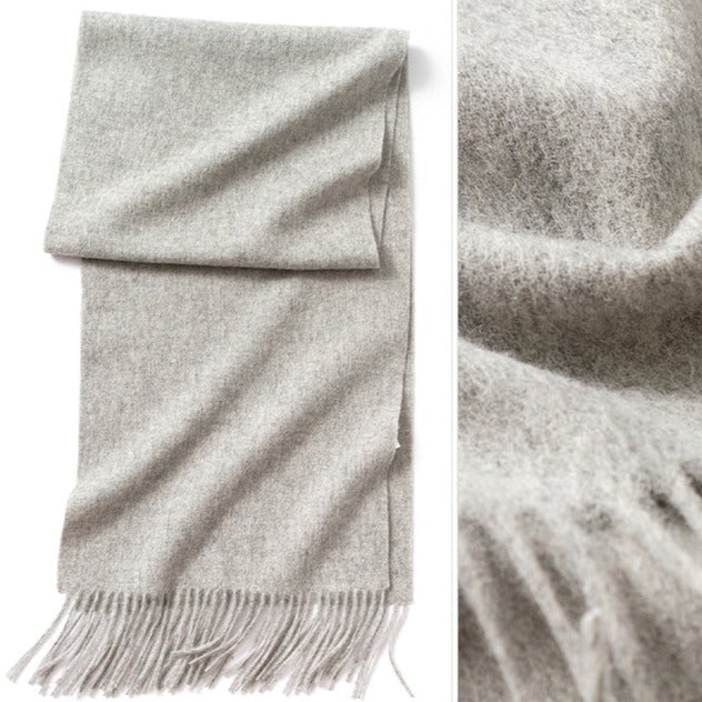 Light Grey Wool Scarf | The scarf is made from high-quality merino wool, ensuring maximum warmth and comfort on even the coldest days. The generous length provides ample coverage, while the tassels add a touch of personality and charm to your outfit.  Available in 12 vibrant and earthy colors, our wool scarf is perfect for adding a pop of color to any outfit. From classic neutrals to bold and bright shades, there's a color to suit every taste and style.
