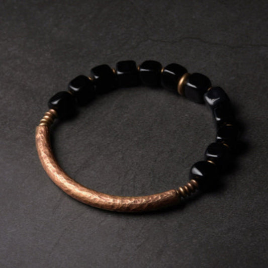 This exquisite handmade Obsidian Copper Bracelet is a true statement piece that exudes elegance and sophistication. Crafted from premium quality copper and adorned with sleek, glossy black Obsidian stones, this bracelet is a unique fusion of natural beauty and artisanal craftsmanship