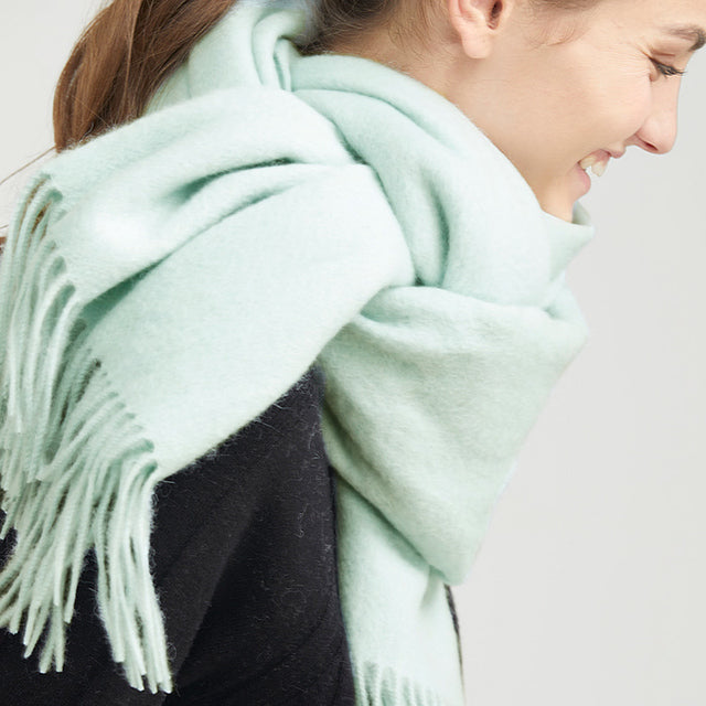 Mint Green Wool scatf | The scarf is made from high-quality merino wool, ensuring maximum warmth and comfort on even the coldest days. The generous length provides ample coverage, while the tassels add a touch of personality and charm to your outfit.  Available in 12 vibrant and earthy colors, our wool scarf is perfect for adding a pop of color to any outfit. From classic neutrals to bold and bright shades, there's a color to suit every taste and style.
