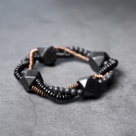 Made with high-quality materials, this bracelet features volcanic lava stones that are said to have grounding and calming properties, as well as beautiful ebony wood and copper accents that add a touch of elegance and sophistication.