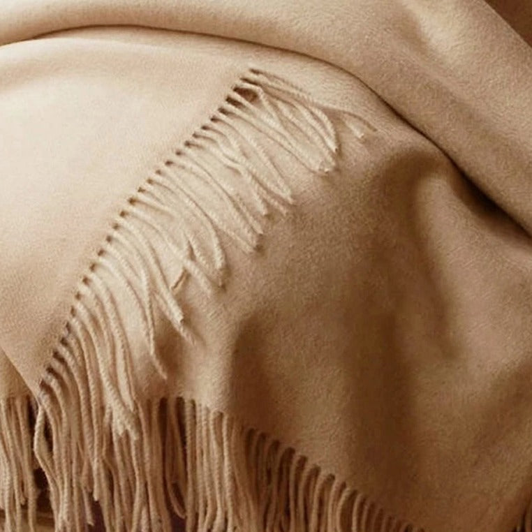 Beige wool scarf | Stay cozy and stylish this season with our 100% merino wool scarf. This scarf is not only soft and warm, but also long and stylish, with tassels that add a playful and chic touch.