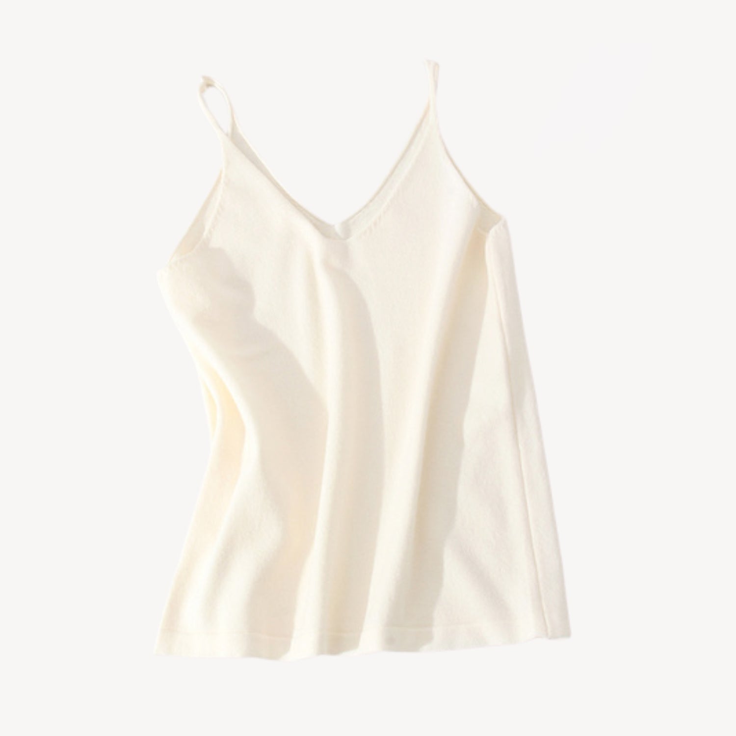 Ivory wool tank top | Whether you're heading to the beach or running errands around town, our knit jersey tank top is a must-have for any summer wardrobe. Its timeless style ensures that it will be a wardrobe staple for years to come, while its soft and lightweight material makes it a comfortable choice for everyday wear.